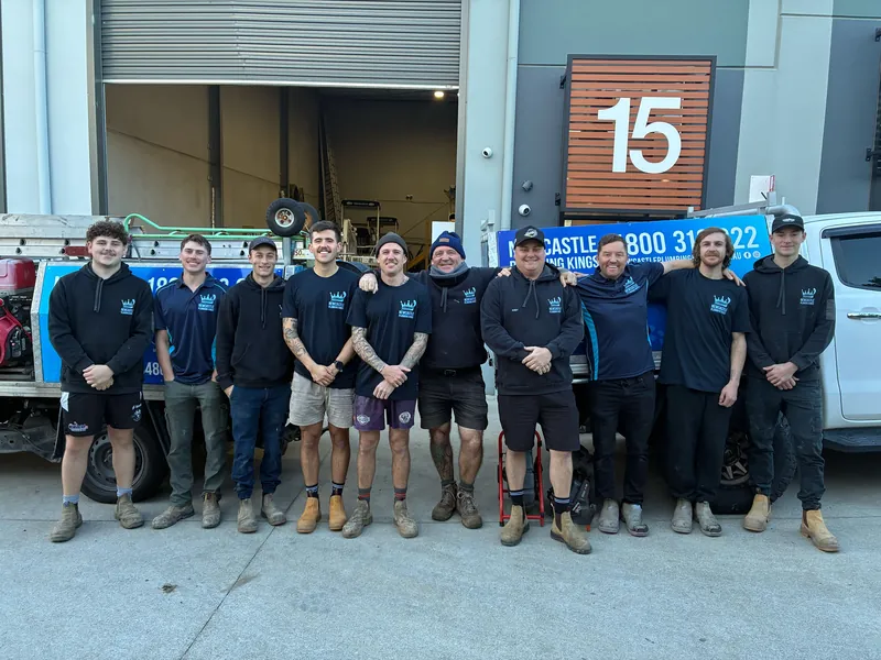 The plumbing team standing beside the work ute